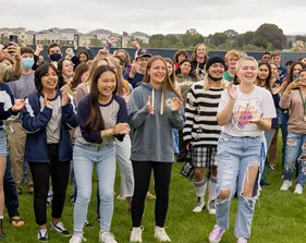 A large group of students clapping in excitement.