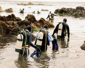 Divers enter the ocean for a dive