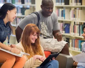 A photo of the CSUMB students reading in the library