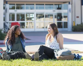 A photo of CSUMB students sitting in front of the University Center