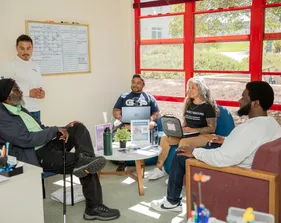 A group of people sitting around a meeting table