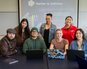 Group of students posing for a group photo in the classroom