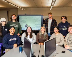 A group portrait of statistics students in a classrooom