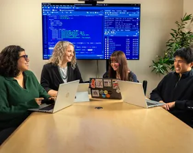 Several statistics students and Judith Canner in a meeting