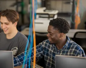 Two students collaborating together in the business and information technology building