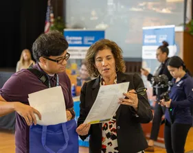 A student and a recruiter talking at a career fair