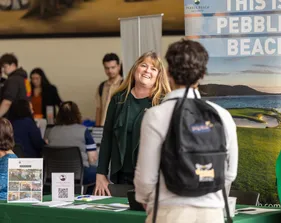 A picture of a student and an employer at the career fair