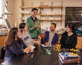 A group of AES students collaborating together in a lab while using molecular models