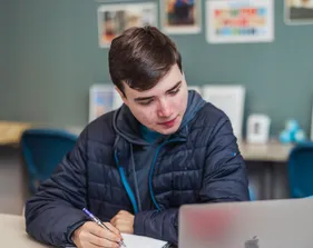 A global studies student taking notes