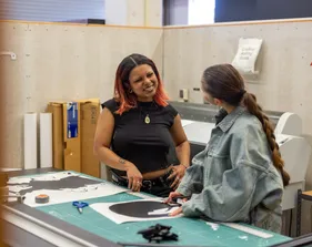 Students talking in an art room.