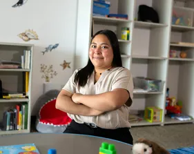 Student smiling in a classroom for a portrait.