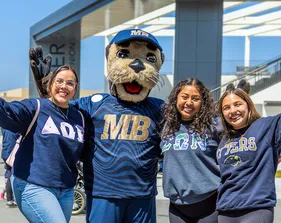 Three students and a mascot