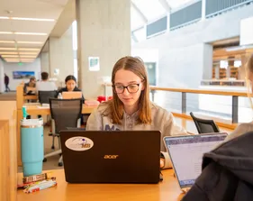 Student using laptop in the library