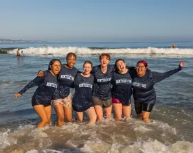 Students posing on the water edge