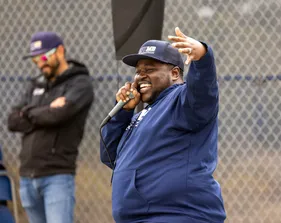 Person with microphone up to mouth