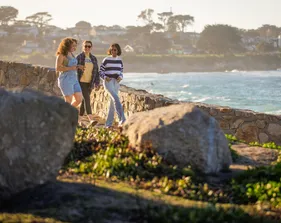 Students walking beside the sea