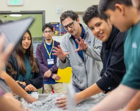 Teacher speaking to students about an experiment