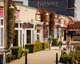 Students cycling by restaurants