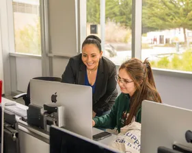 Two team members looking at a computer screen
