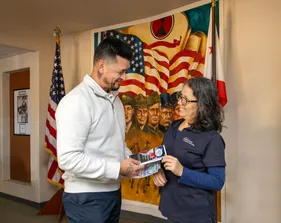 Two people are looking at each other and smiling