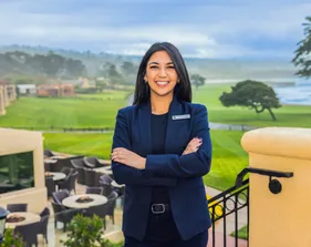 A girl in a blue blazer poses for a photo.
