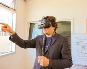 A boy is wearing Virtual Reality glass