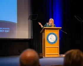 Woman speaking in front of the audience