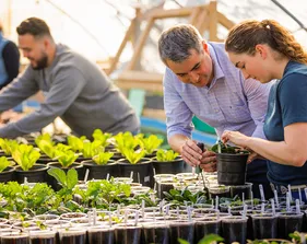 Staff and faculty working in the greenhouse