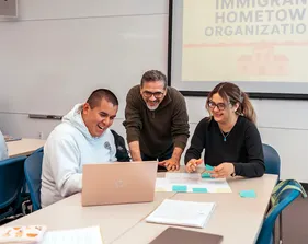 A professor working with two students