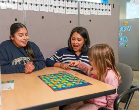 CSUMB special education credential students supporting a child through educational game-based learning