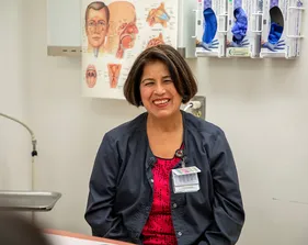 A woman is smiling for a photo