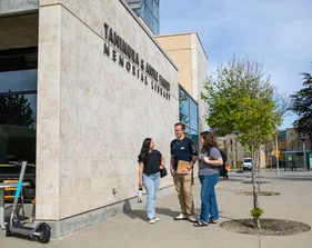 Students standing outside the exterior of the library