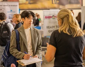 Student meeting with a industry person during career fair