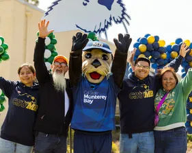 Admitted otter day 2025, new students and parents with Monte celebrating