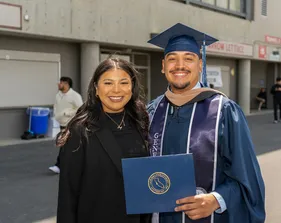 A graduate and a family member posing for a photo