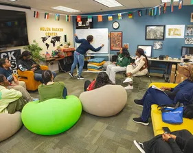 A group of students around a white board at the Helen Rucker Center