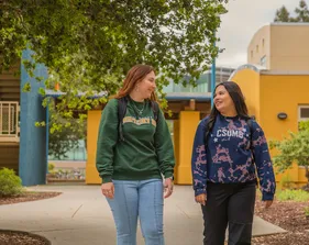 Two students walking on campus