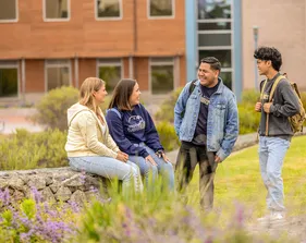 Four students chatting on campus