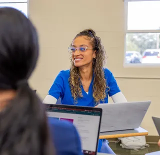 Nurse with laptop in class