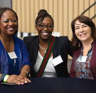 Three people at the community welcome reception