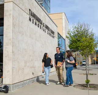 Students standing outside the exterior of the library