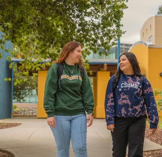 Two students walking on campus