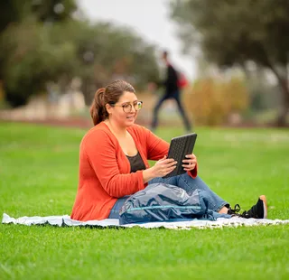 Student reading on blanket