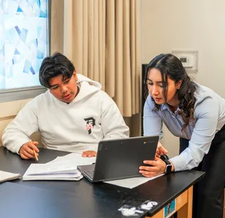 Masters student teaching a class of young students in a classroom.