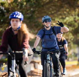Students cycling in a park