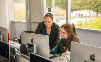 Two team members looking at a computer screen