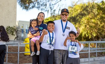 Family with children posing at race finish