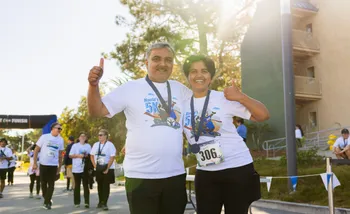 2 runners smiling at finish line