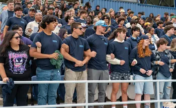 Student link their arms, demonstrating how otters 