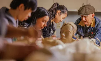 Students doing Pottery with a professor